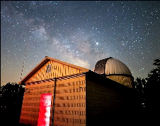 A building with a dome and a red door

Description automatically generated