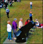 A group of people looking at a telescope

Description automatically generated